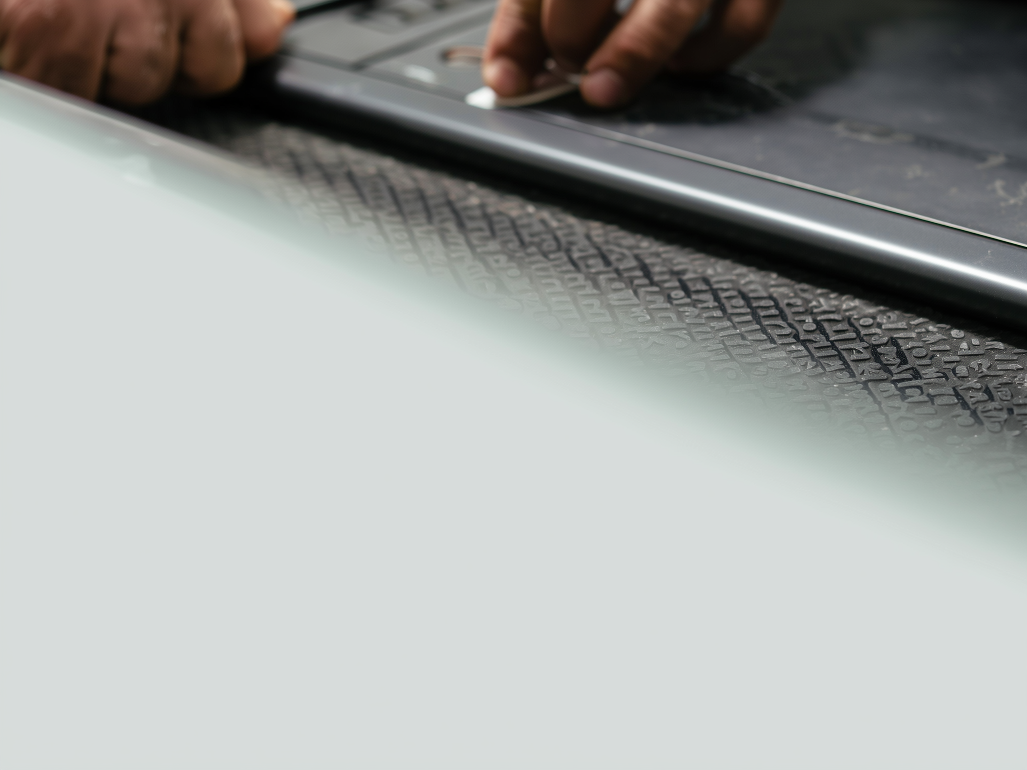 Close-up of hands typing on a laptop keyboard