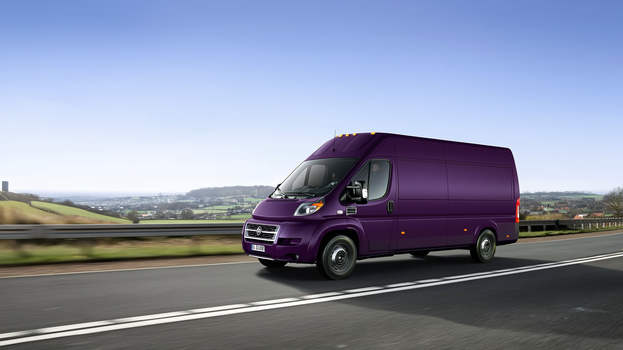 Purple delivery van driving on a highway with countryside landscape visible