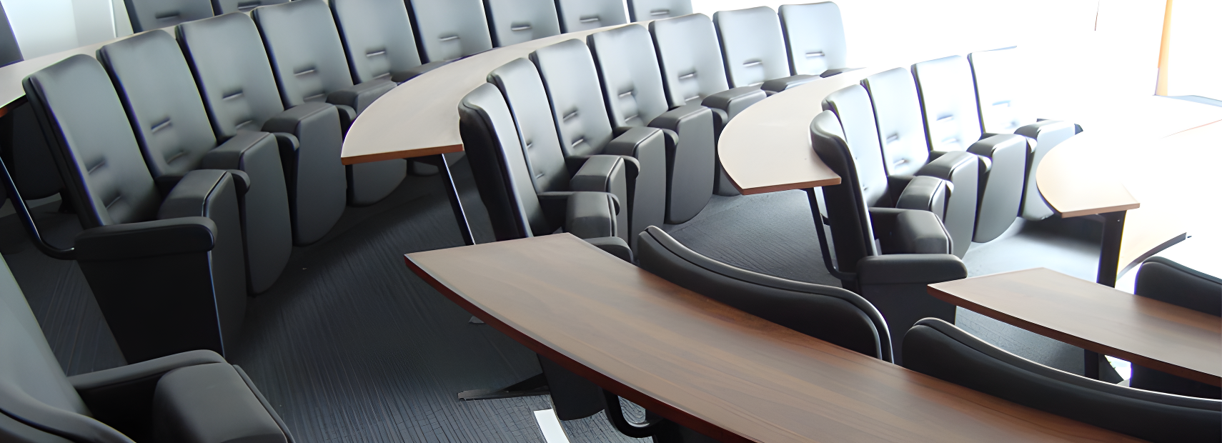 Classroom with tablet-arm chairs arranged in curved rows facing forward
